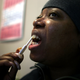 A woman uses the Oraquick rapid HIV testing device at the South Brooklyn Health Center Feb. 7, 2006, in New York City.